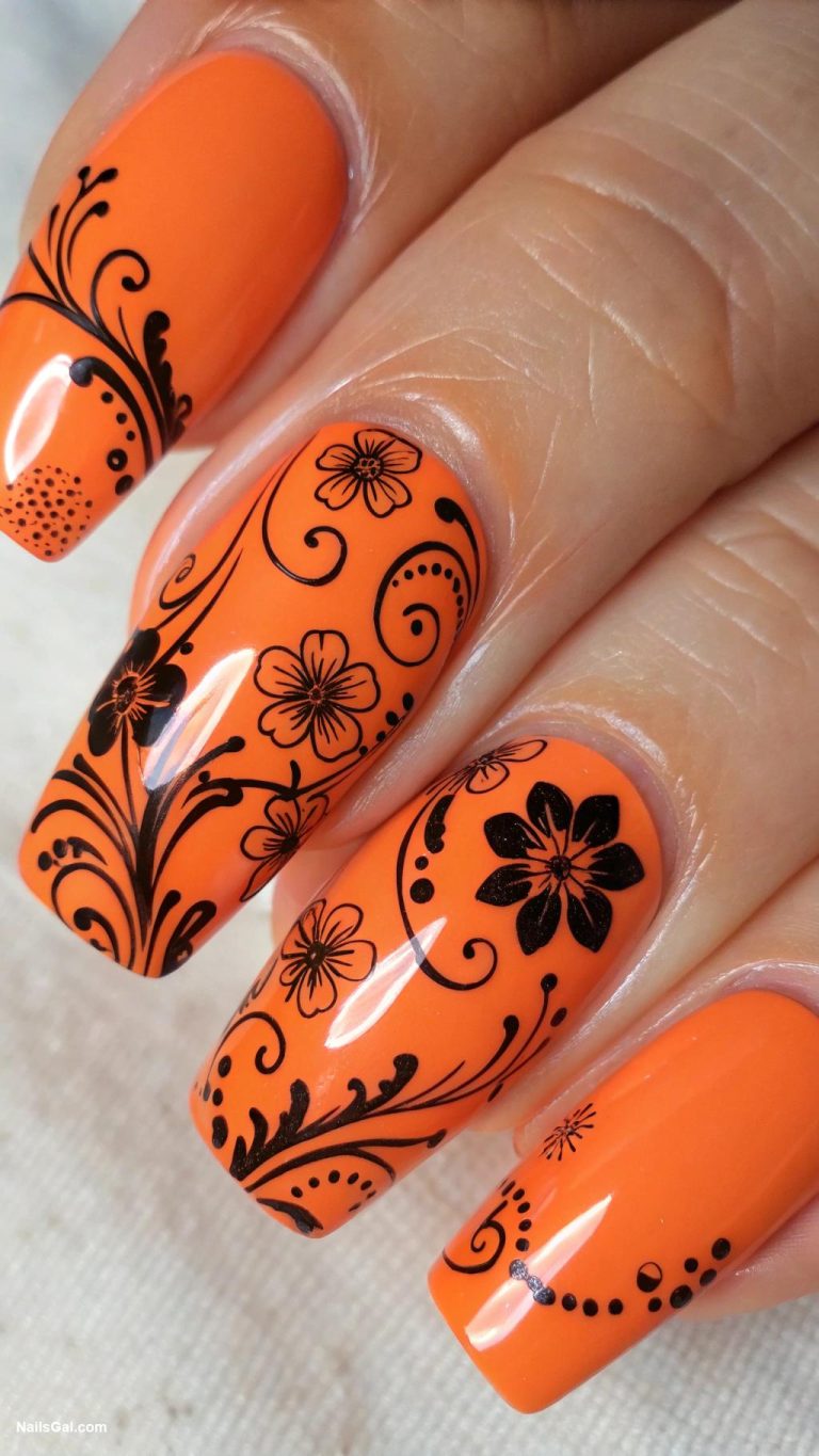 black and orange nails Orange base with black floral art