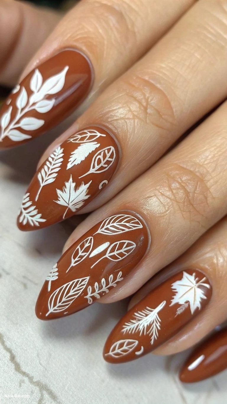 fall nail ideas Cinnamon brown with white leaf silhouettes